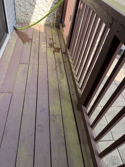A wood deck with mildew and weathered graying before cleaning