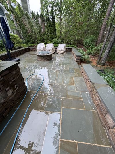 Same flagstone patio after cleaning, moss removed and natural color restored