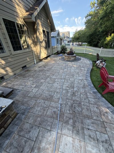 Stamped patio with dark staining before cleaning