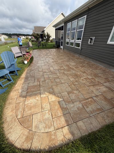 Same stamped patio after cleaning, staining removed and warm tone restored