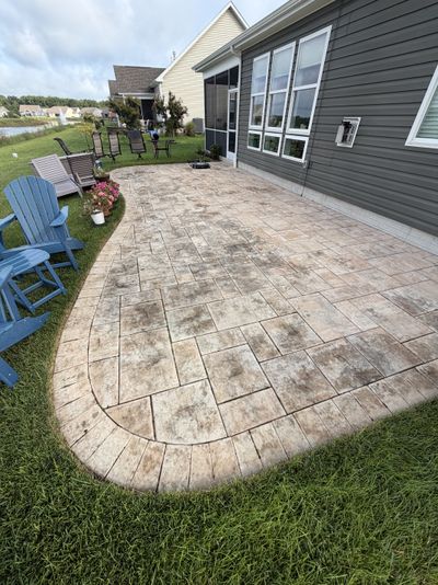 Stamped patio with heavy dark staining before cleaning